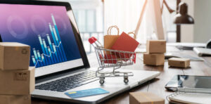 A shopping cart toy placed on the laptop touchpad