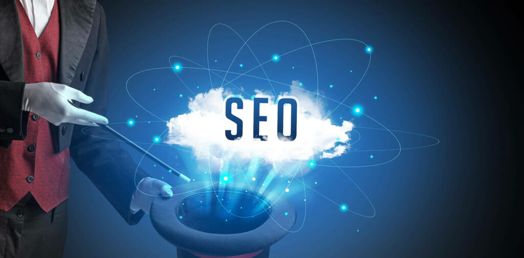 The magician who holds a wand & black hat pulls words SEO from it