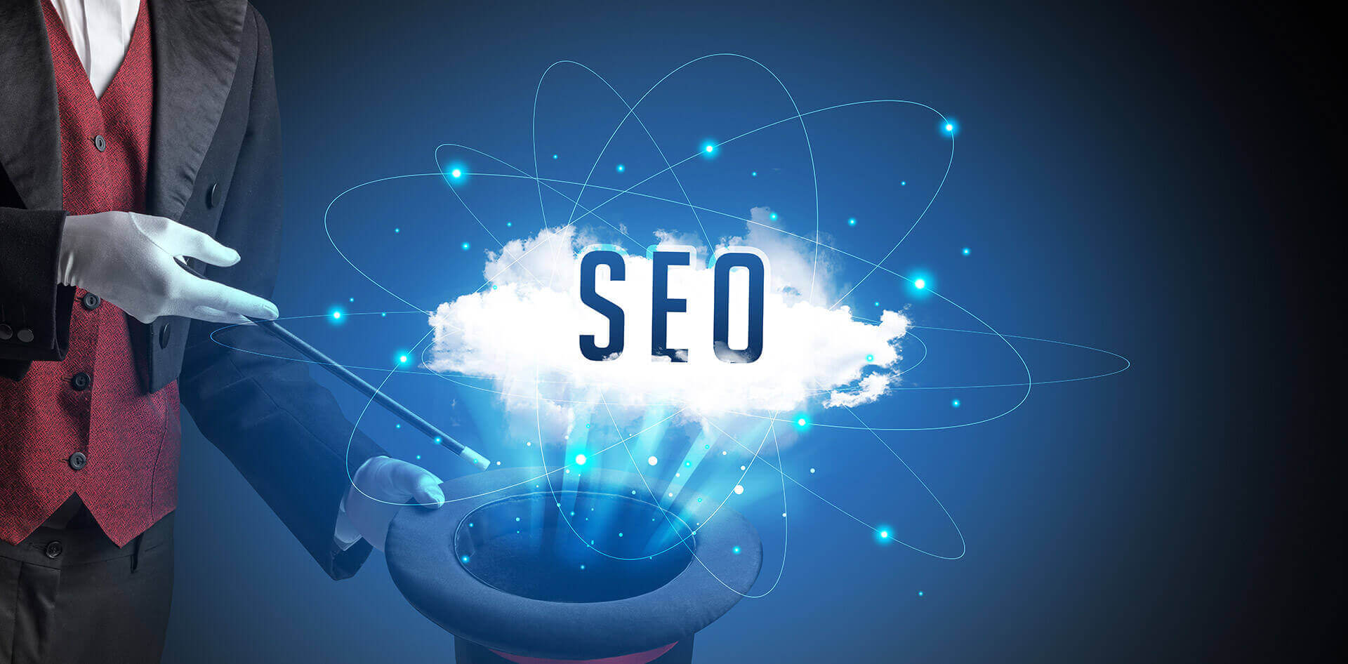 The magician who holds a wand & black hat pulls words SEO from it